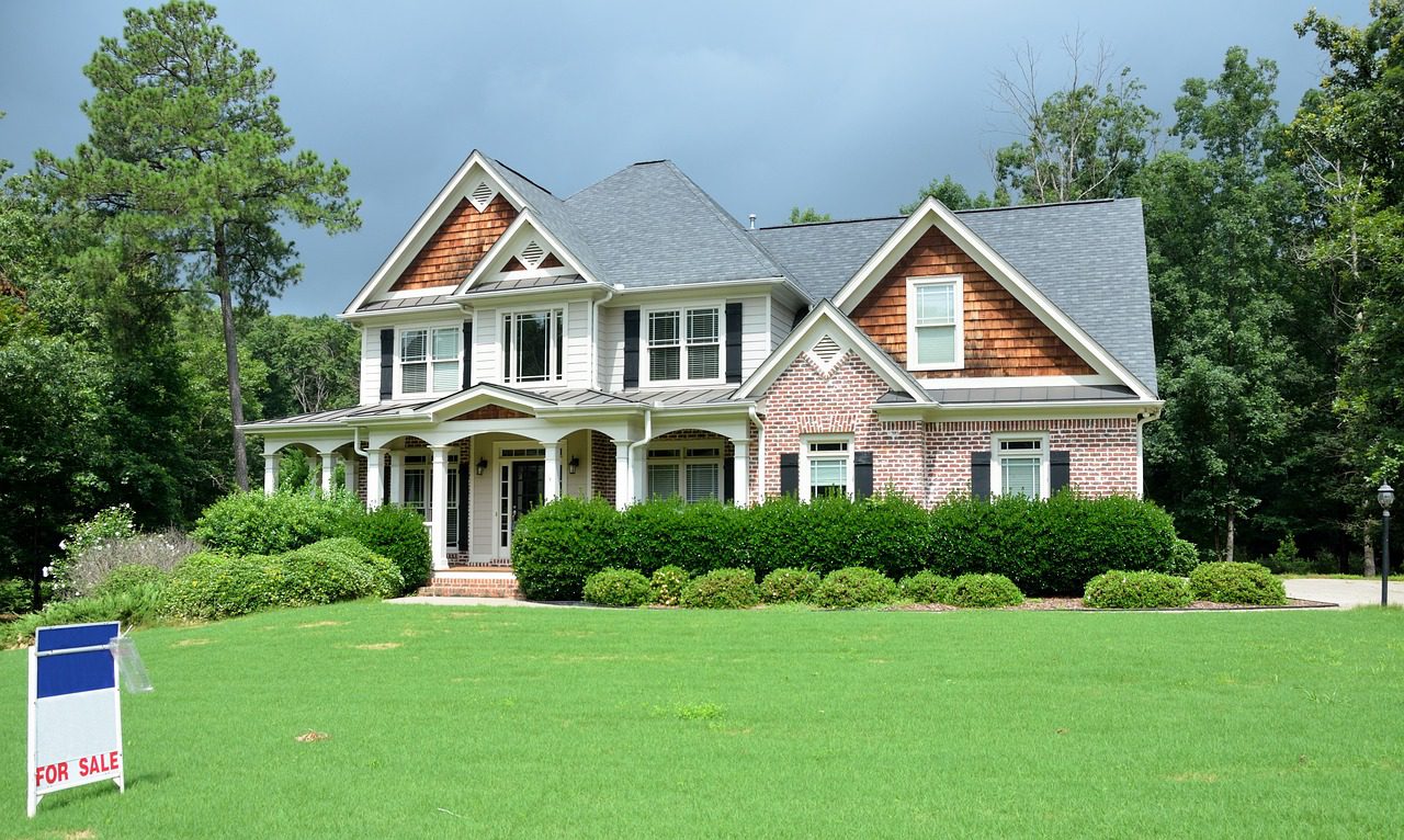 A large house with green grass in front of it.