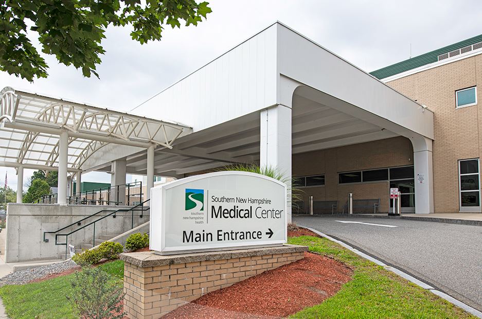 Main entrance of a medical center with clear signage and walkway.