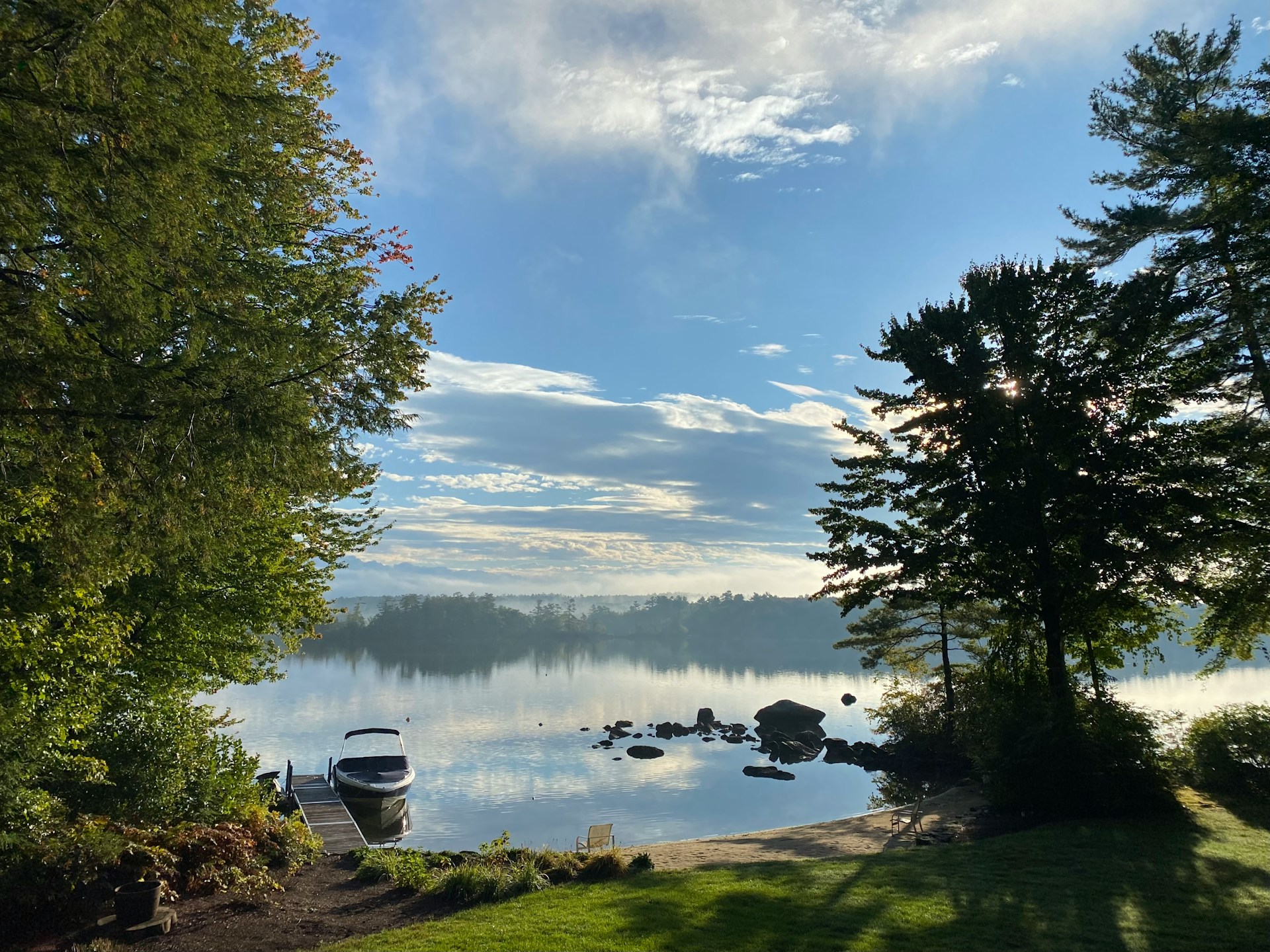 Private dock and boat on Lake Winnipesaukee NH on a calm morning