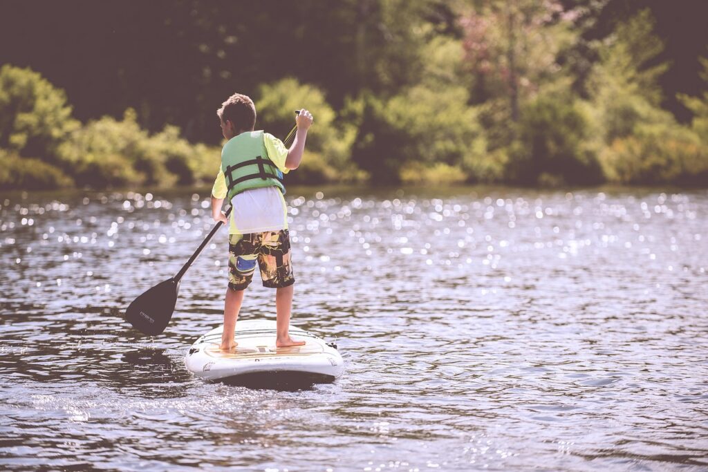 Boy paddling on a pond