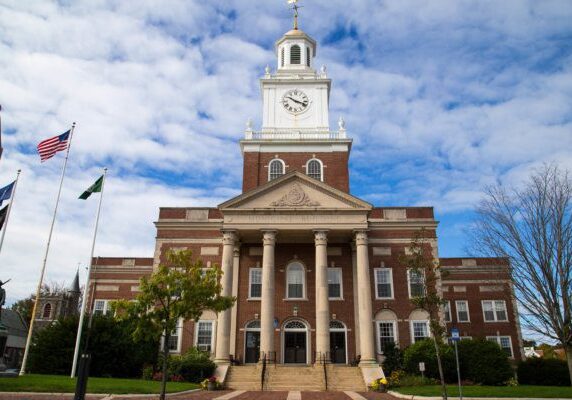 A large building with a clock tower in the center.